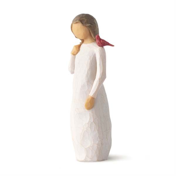 Small angel figurine in a white dress with a red bird on her shoulder