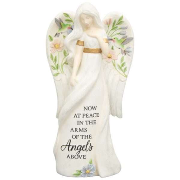White angel figurine with floral accents and memorial text