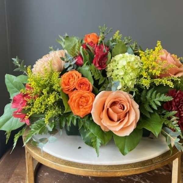 Mixed bouquet of roses, hydrangea, and other blooms on a table