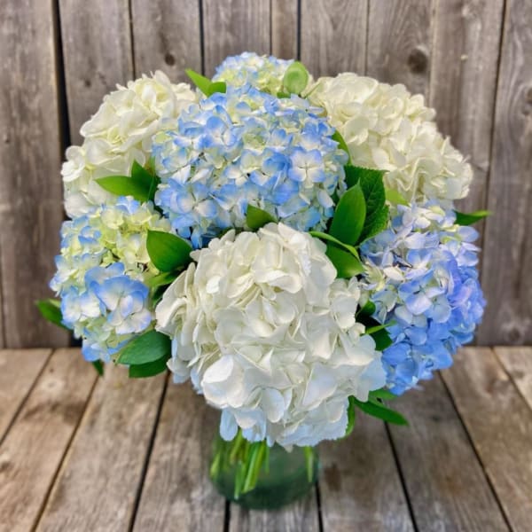 Blue and white hydrangea bouquet in a glass vase