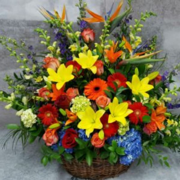 Colorful mixed flower arrangement in a wicker basket