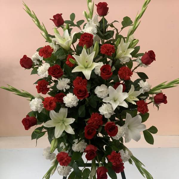 Standing floral spray with red roses, white lilies, and carnations