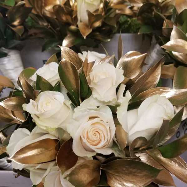 White rose bouquet with metallic gold leaves