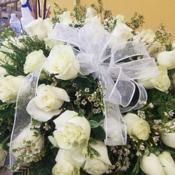 White rose bouquet with a sheer white ribbon bow