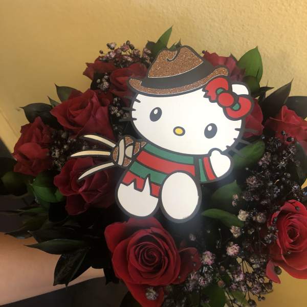 Red rose bouquet with a Hello Kitty topper