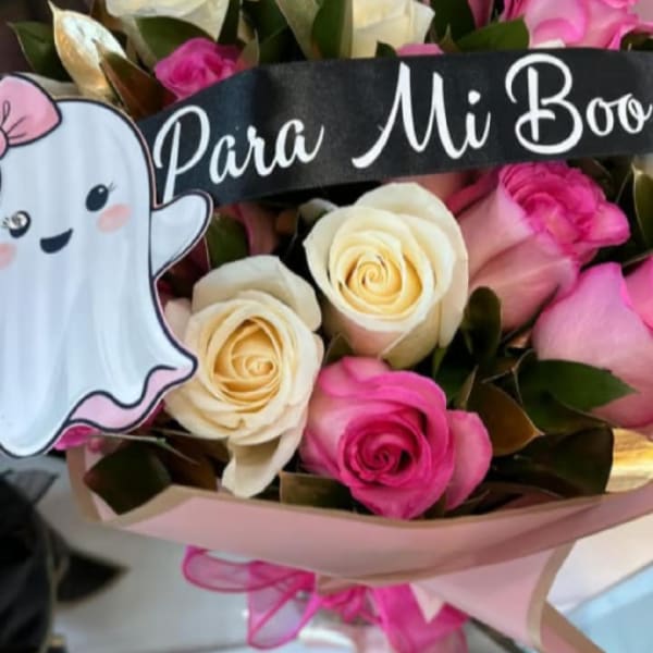 Bouquet of pink and cream roses with a ghost decoration and banner