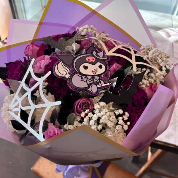 Bouquet of pink and purple roses with decorative cutouts and a cartoon topper