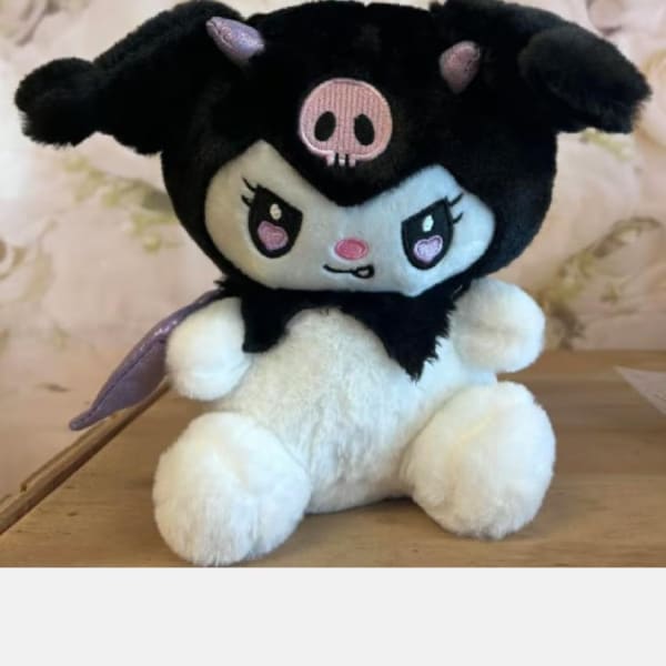 Plush black-and-white character stuffed animal sitting on a table