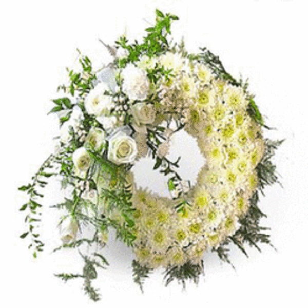 Heart-shaped floral wreath with white flowers and greenery