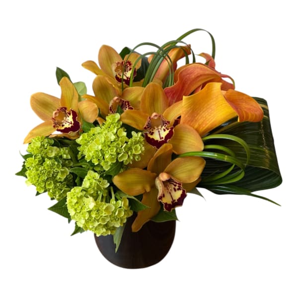 Orange orchids and green hydrangeas in a dark vase