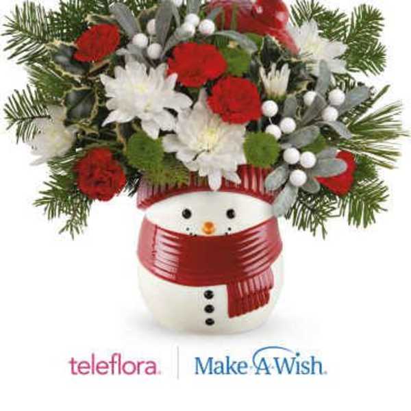Holiday bouquet in a snowman container with red and white flowers