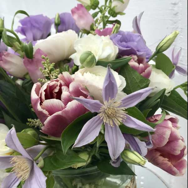 Bouquet of pink, white, and lavender flowers in a glass vase