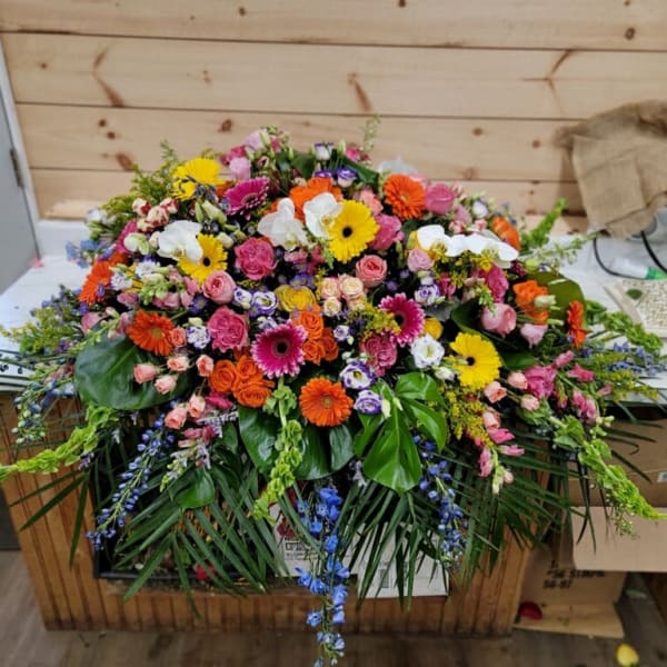Large colorful floral arrangement with gerbera daisies and roses