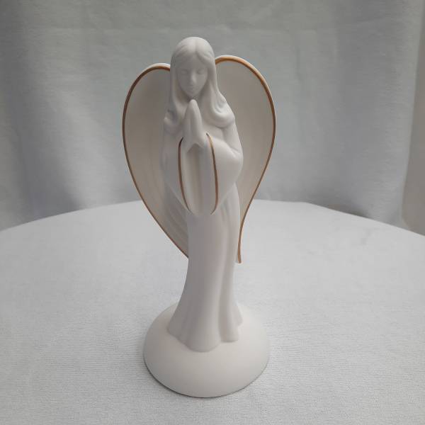 White angel figurine with folded hands and gold-trimmed wings