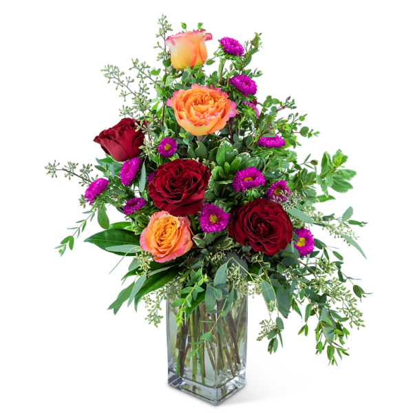 Mixed bouquet of red and orange roses in a clear glass vase
