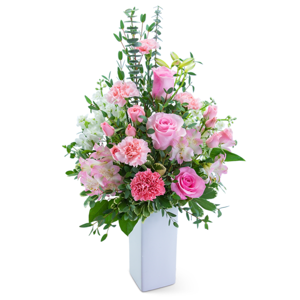 Pink and white floral arrangement in a tall white vase