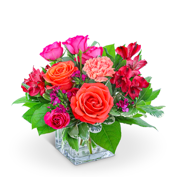 Pink and orange roses with red alstroemeria in a glass vase
