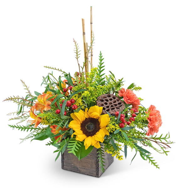 Sunflower arrangement in a wooden box with orange blooms and berries