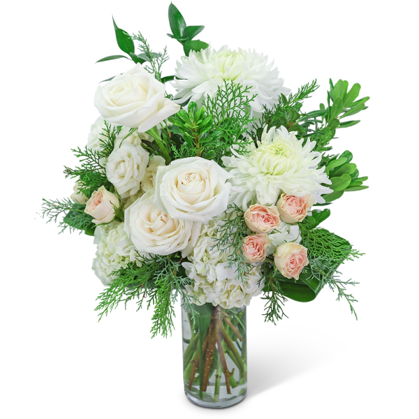 White roses and chrysanthemums in a clear glass vase with greenery
