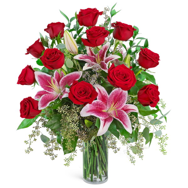 Red roses and pink lilies in a clear glass vase