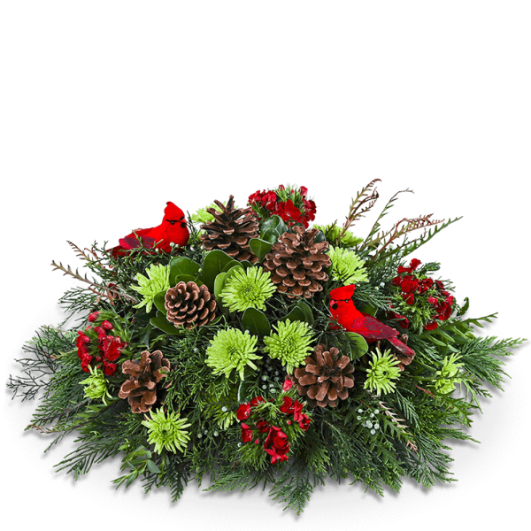 Holiday arrangement with red flowers, pinecones, and green foliage