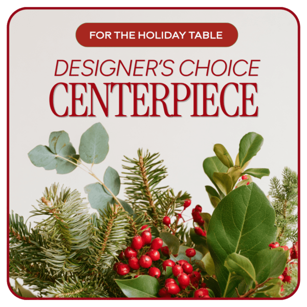 Holiday table centerpiece with evergreen branches and red berries
