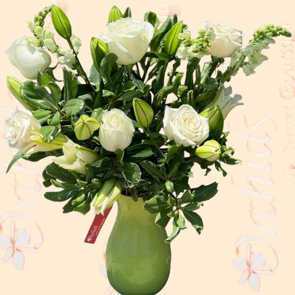White roses and lily buds in a green vase