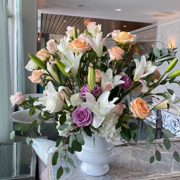 Large bouquet of roses and lilies in a white vase
