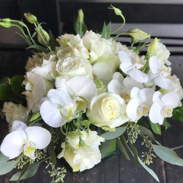 White rose and orchid bouquet with greenery