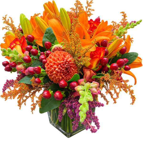 Orange and red floral arrangement in a clear glass vase