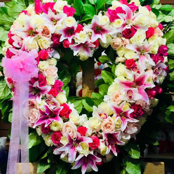 Heart-shaped floral wreath with pink and white roses and lilies