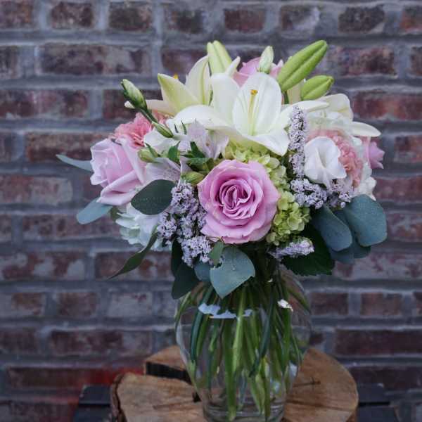 Pink and white bouquet in a clear glass vase