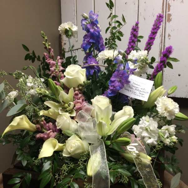 Large mixed bouquet with white lilies, roses, and purple flowers