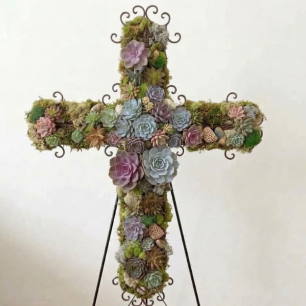 Cross-shaped succulent arrangement on a metal stand