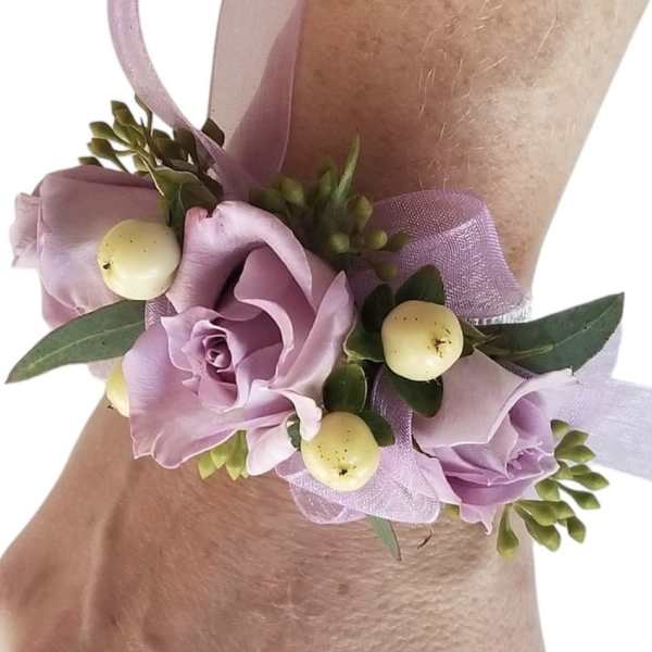 Lavender rose wrist corsage with ribbon and pale berries