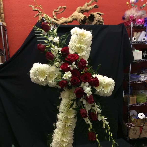 Cross-shaped floral spray with red roses and white chrysanthemums
