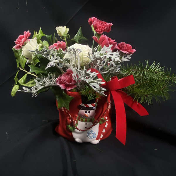 Christmas bouquet in a snowman container with red ribbon