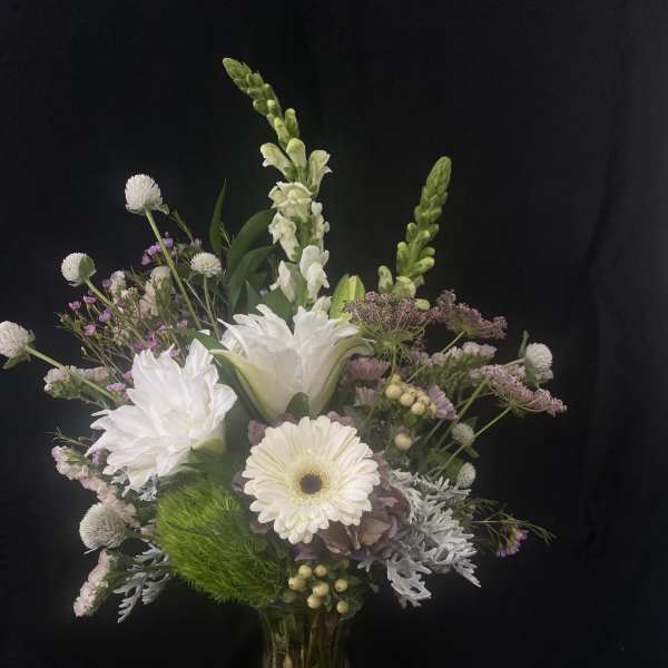 White and pale lavender mixed bouquet in a glass vase