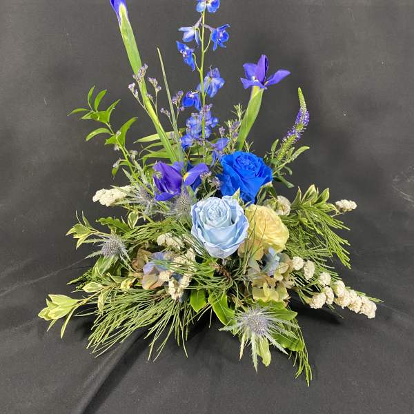 Blue and purple floral arrangement with roses and iris