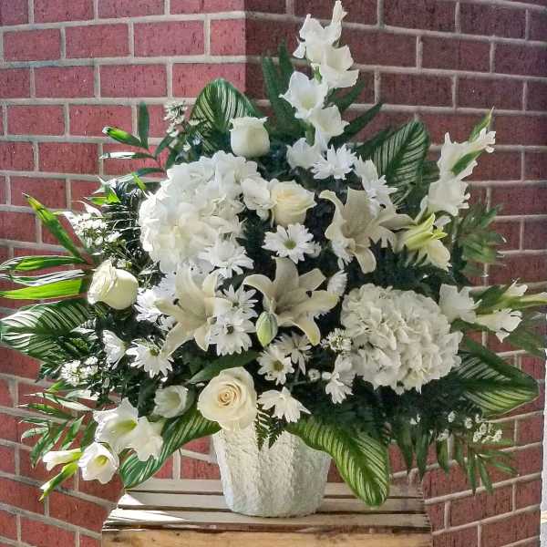 White floral standing spray in a white vase