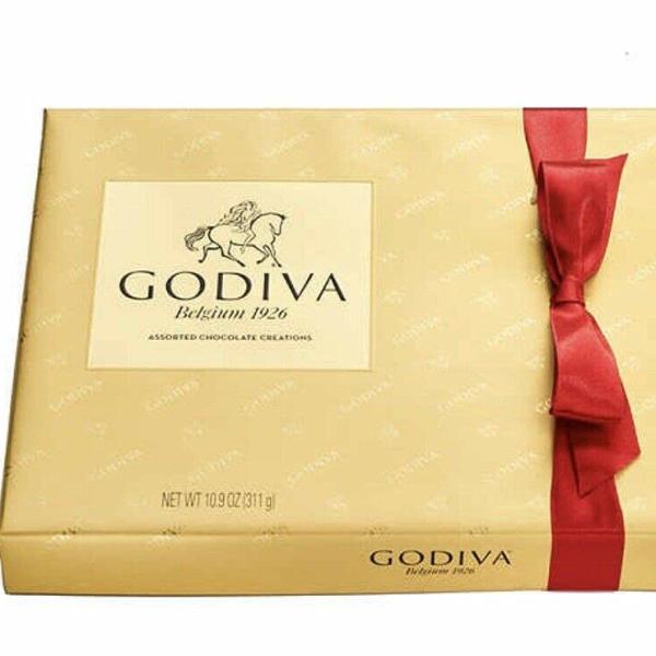 Gold Godiva chocolate gift box with a red ribbon