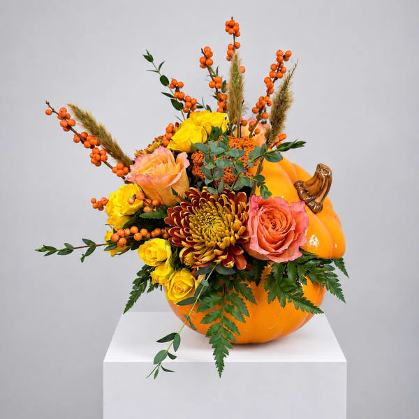 Pumpkin-shaped arrangement with roses, mums, and orange berries