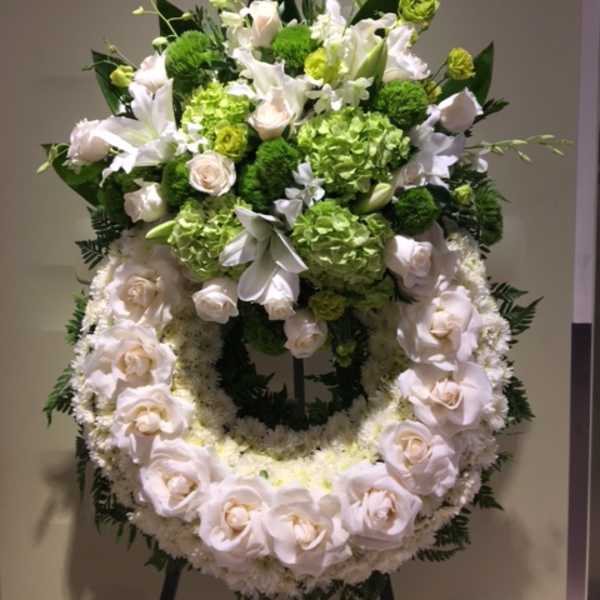 Standing floral wreath with white roses and green blooms