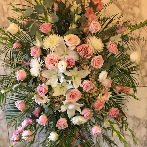 Large pink and white floral standing spray with roses and lilies