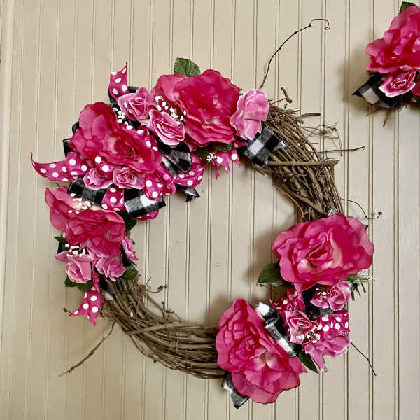 Pink floral wreath with ribbon on a twig base