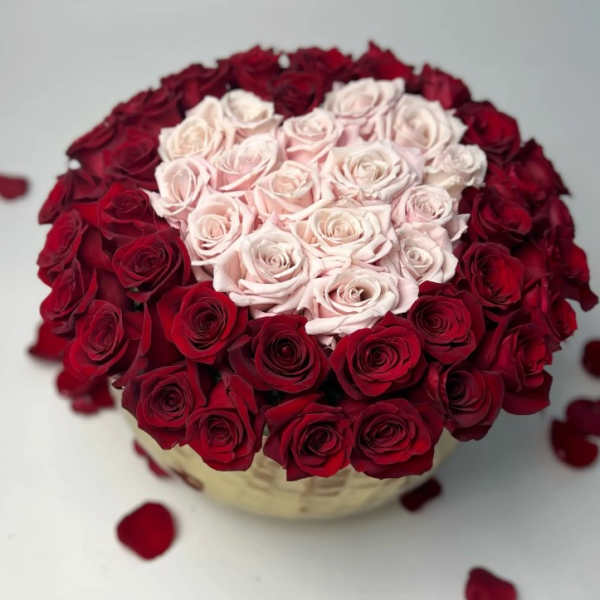 Heart-shaped rose arrangement with pale pink center and red outer roses