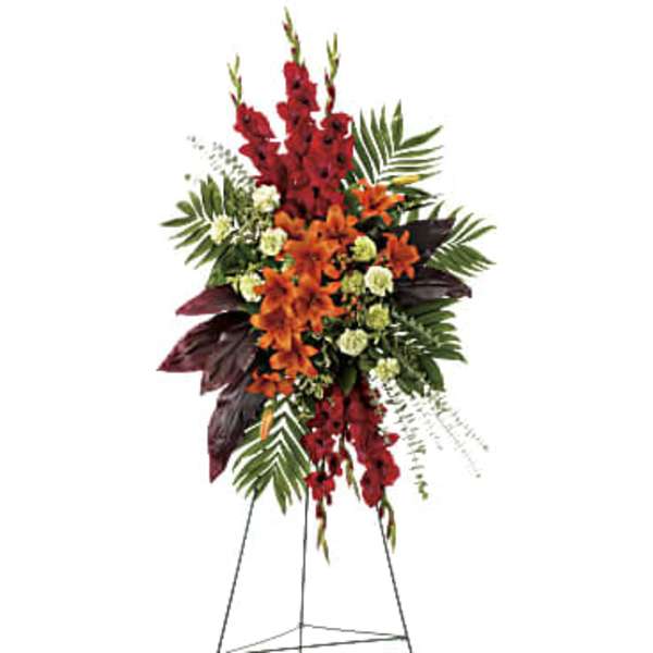 Tall red and orange floral standing spray on an easel