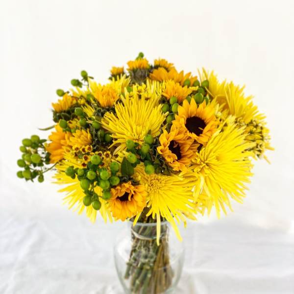 Yellow mixed bouquet in a clear glass vase