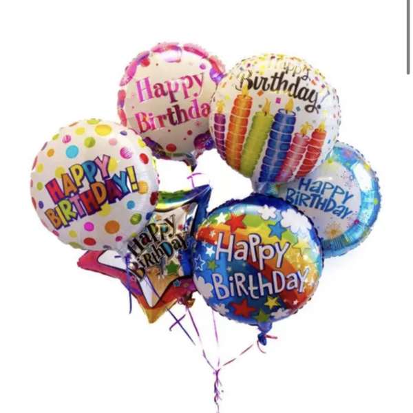 Cluster of colorful birthday balloons with printed messages