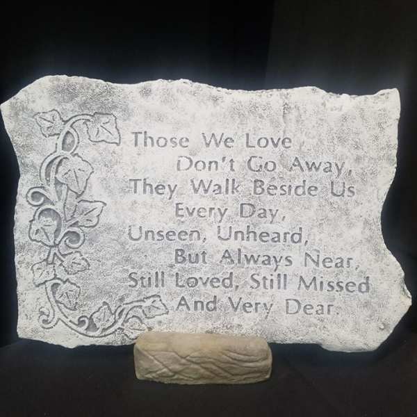 Engraved memorial stone with a floral vine design and sympathy quote